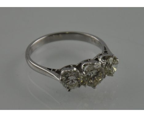 A three stone diamond ring, approx. 1.91ct, set in a white metal band stamped 18ct, 3.6g.