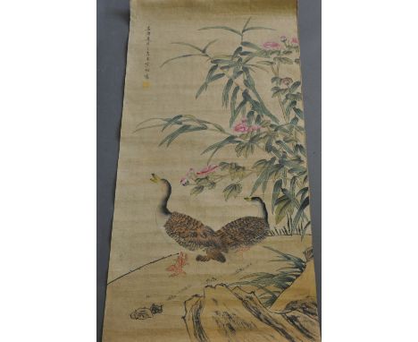 A Chinese scroll, depicting ducks below bamboo and flowers, L. 90cm