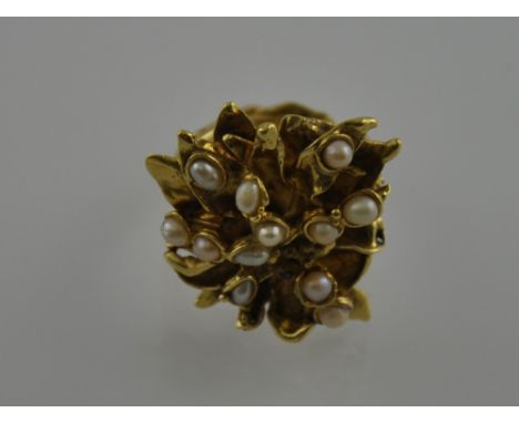 An 18ct yellow gold freshwater pearl flowerhead cluster dress ring, with entwined leaf band, 19g gross