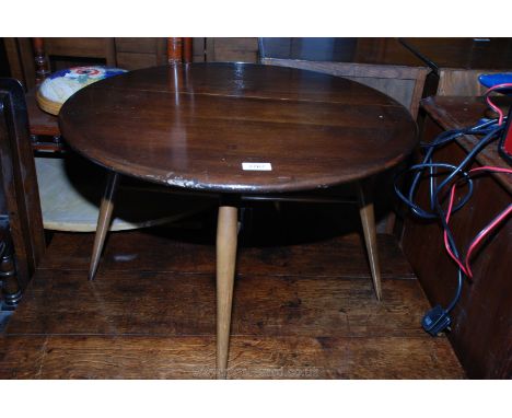 An Ercol dark-stained demi-lune Occasional Table, a gate-leg supporting a single drop leaf to form a circular top. 24 1/2'' d