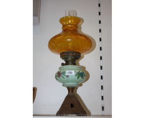 An Oil Lamp with green milk glass reservoir and hand-painted design with orange shade.
