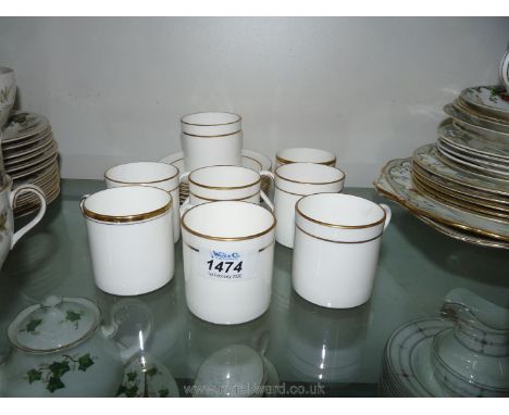 Eight Royal Worcester coffee Cans and saucers, white ground with gilt rim