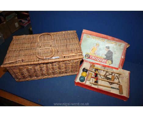 A vintage game 'The Popular Game of  Croquet' and a vintage picnic basket.