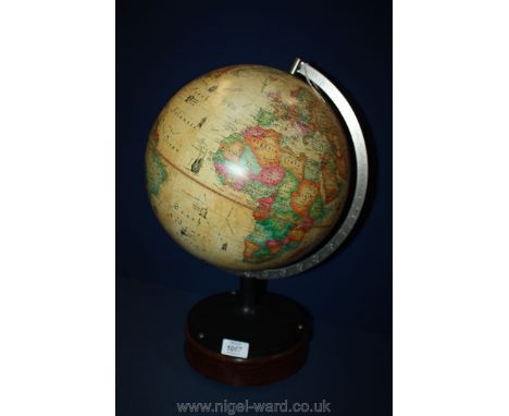 A vintage 'World Discoverer' Globe mounted on a Mahogany stand with bun feet.