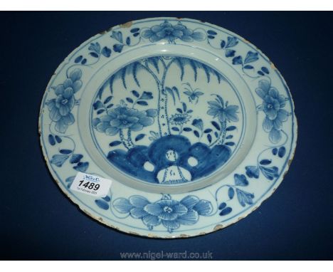 A good English Delftware charger circa 1750, 30cm, painted in blue with a willow tree among flowers in the manner of Liverpoo