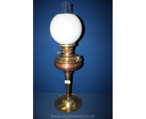 A brass and copper Art Nouveau style Oil Lamp and shade.