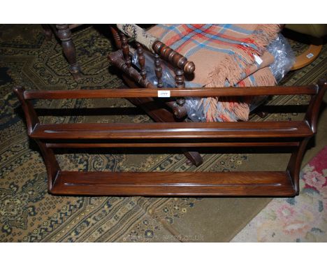 An Ercol dark-stained wood wall-hanging Plate Rack, 38'' long x 19 1/2'' high x 5 1/4'' deep.