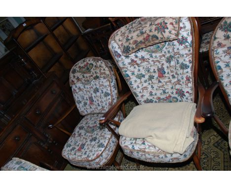 A pair  Ercol stick-back lady's and gentleman's Armchairs with cushions upholstered in Sanderson's Hog Hunting landscape scen