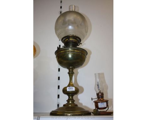 A brass oil lamp with frosted shade and a small hand-held oil lamp.