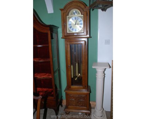 A contemporary Oak Cased Long-case Clock having a three-train movement striking the hours and quarter hours, the arched face 