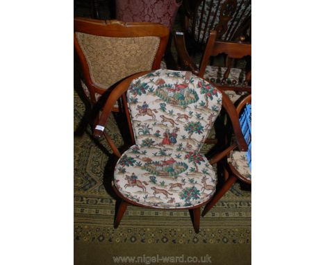 An Ercol stick-back Windsor Chair with cushions upholstered in Sanderson's Hog Hunting landscape scene fabric.