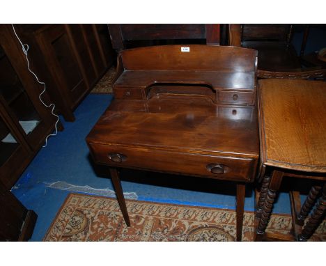 An Ercol dark-stained compact Writing Desk having a frieze drawer and up-stand with two trinket drawers. 27'' wide x 18 3/4''