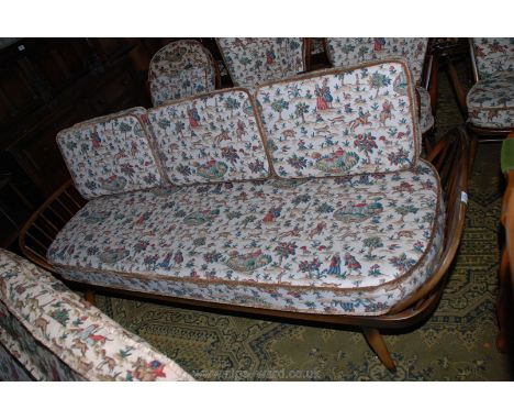 An Ercol three-seater Bed Settee with cushions upholstered in Sanderson's Hog Hunting landscape scene fabric.