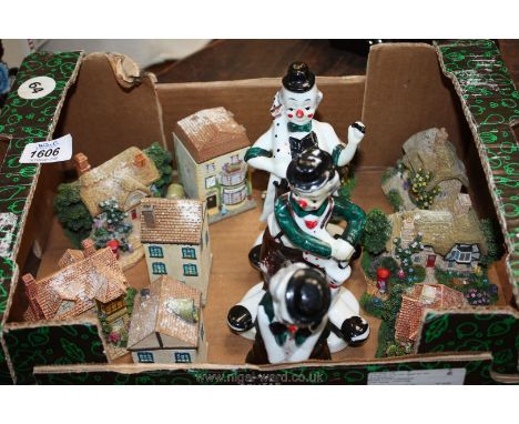 Three vintage china clowns and a selection of miniature stone cottages.