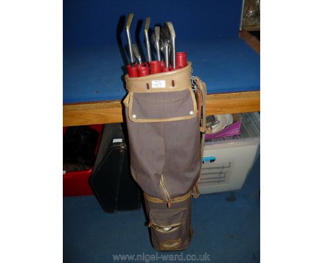 A vintage Golf bag, seven of Bobby Locke Triple Crown Golf clubs and various golf balls