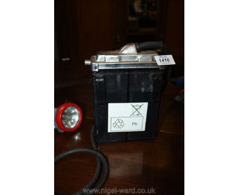 A Miner's head lamp with lead-based re-chargeable battery pack.