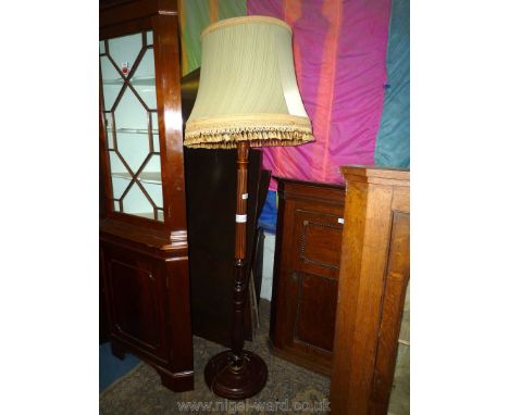 A lobed pillar Mahogany Standard Lamp having turned base and Acanthus leaf details, complete with tasselled beige shade. 60''