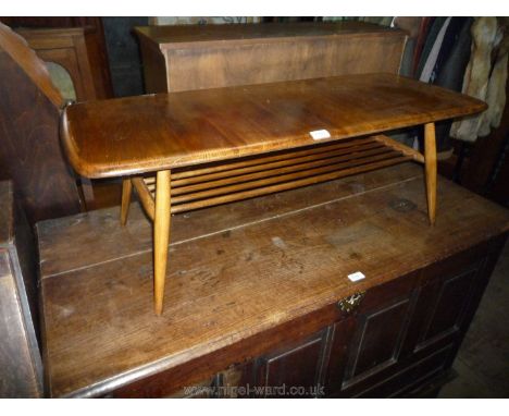 An Ercol coffee Table with stick comprised magazine shelf under. 41'' x 17'' x 14'' high.