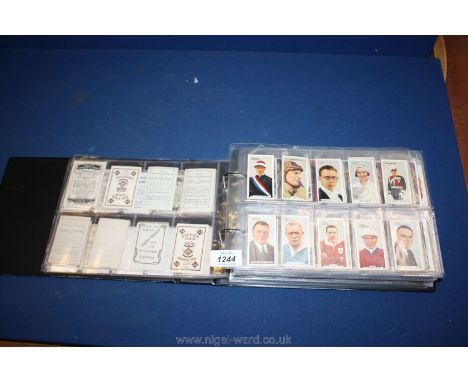 A black folder of Cigarette Cards including vintage film stars, medals, dogs, etc.,