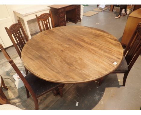 Large circular dining table on single pedestal tripod base with four matching dining chairs