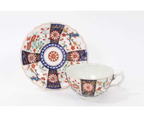 A Worcester Queens pattern teacup, circa 1770, and a later saucerCondition report: The cup has a small restored rim chip and 