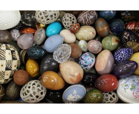 Large collection of decorative eggs, in a variety of mediums, including modern Fabergé etched glass, Baccarat purple tinted g