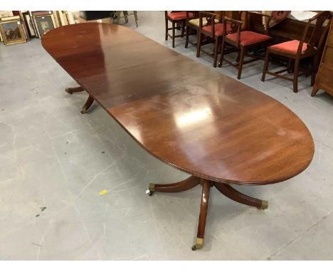 Regency style twin pedestal dining table, with rounded rectangular top on readed edge and turned columns on splayed quadruped