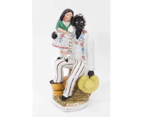 Staffordshire pottery group of Uncle Tom and Little Eva, decorated in enamels with raised gilt title, 26.5cm highCondition re