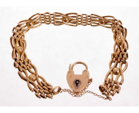 Edwardian yellow metal gate bracelet with padlock clasp, stamped 18ct. Approximately 19.5-20cm length.Condition report: The p