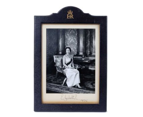 H.M.Queen Elizabeth II, fine signed presentation portrait photograph of The Queen seated in Buckingham Palace, signed in ink 