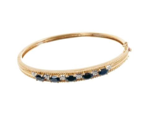9ct gold sapphire and diamond hinged bangle with five oval mixed cut blue sapphires and six single cut diamonds.Condition rep