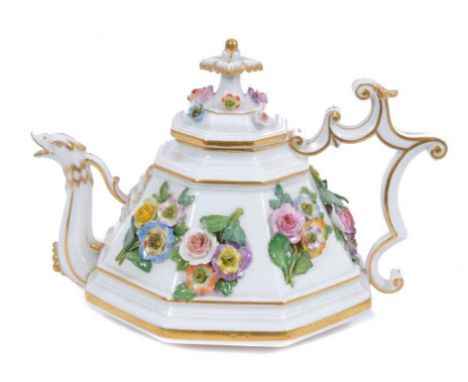 A Meissen octagonal teapot and cover, circa 1860-80, with floral encrusted decoration, scrollwork spout, mask and beast form 