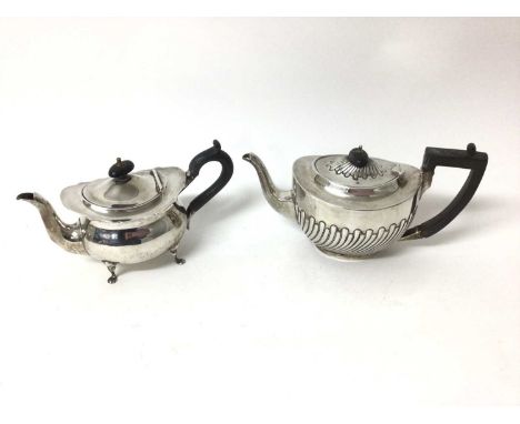 Two silver teapots to include a Edwardian silver bachelor's teapot on four feet, Sheffield 1903, and a Victorian silver teapo