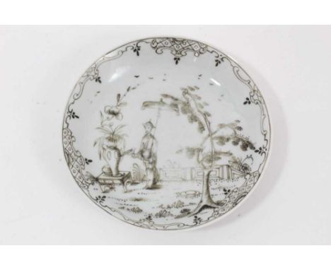 A Worcester saucer, circa 1755, 'pencilled' in Chinese style with a figure holding a parasol in a garden, patterned rim, 12cm