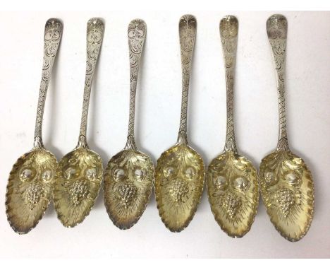 Six Georgian silver berry dessert spoons with matching decoration, the embossed and gilded bowls with chased handles and engr