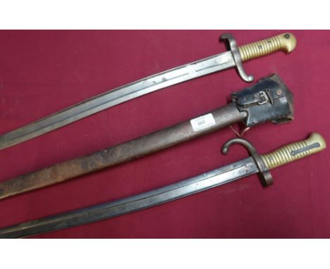 French 19th C bayonet, complete with steel scabbard and leather frog, the top strap dated 1876, and another similar with unus