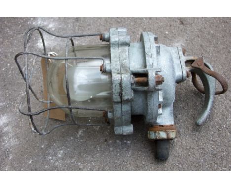 A vintage industrial lamp with encased doomed glass shade, stamped Simplex