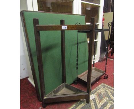 A simple oak freestanding corner umbrella/stick stand with square cut supports together with a three divisional ironwork exam