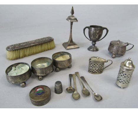 A mixed collection of silver to include a four piece cruet set comprising three salts and a lidded mustard, a twin handled cu