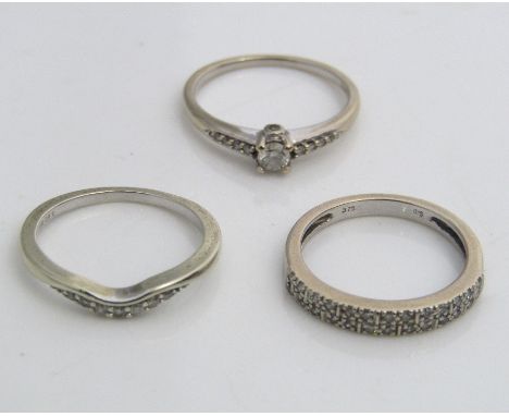 Three diamond set white gold rings; one 18ct example set with central diamond of 0.15cts approx, size K/L and two 9ct example