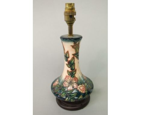 A Moorcroft table lamp base with drawn neck and painted pink clematis type detail on a graduated pink and blue ground, 22cm t