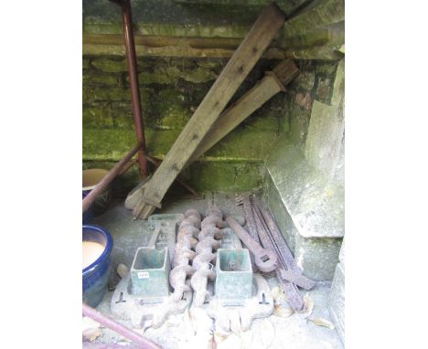 A pair of vintage oak lawn tennis posts with pierced cast iron platform bases initialled SE 
