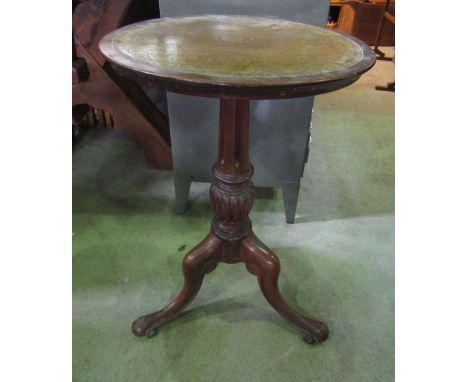 A mahogany occasional table, the circular inset mustard coloured leather panelled top raised on a partially fluted vase shape