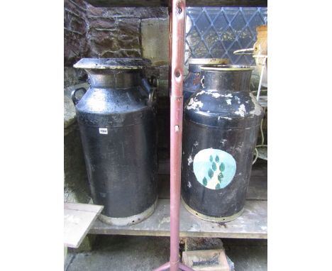 Four vintage milk churns with later painted finish (two complete with caps), together with a stack of six moulded plastic pla