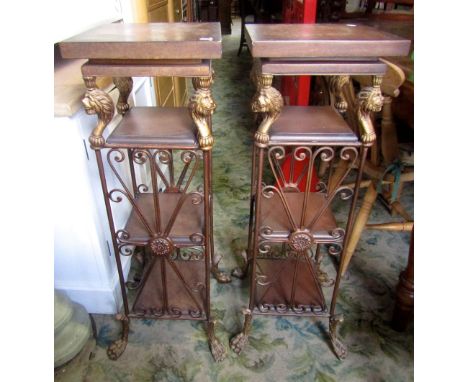 A pair of four tier lamp/jardiniere stands of square form, with lions mask detail and hairy paw feet