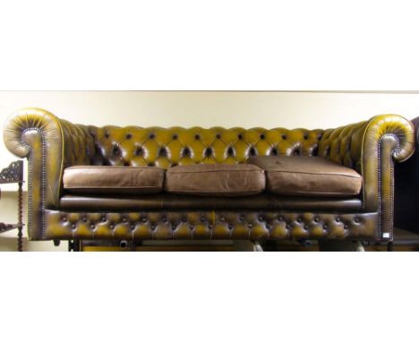 A Victorian style Chesterfield sofa to seat three, with buttoned leather finish in an antique gold colourway, 210cm wide