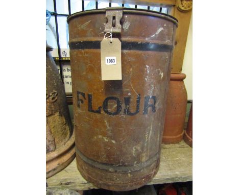 A vintage cylindrical tin flower bin with simulated painted wood grain finish and hinged lid with oval brass plaque Thomas W 
