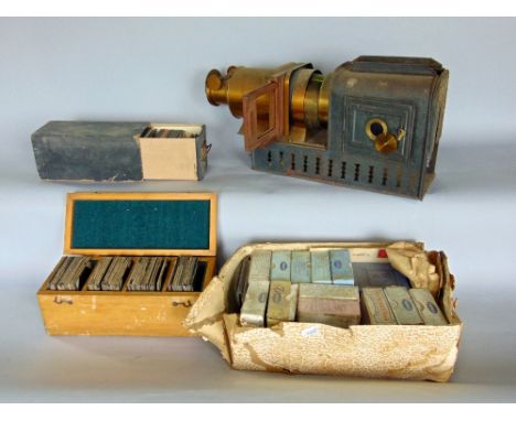 A vintage brass and tin magic lantern with a collection of vintage slides, many in original cases