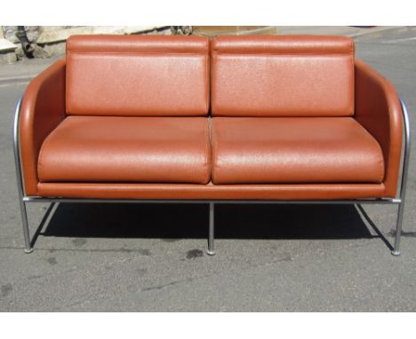 Corinto of Italy tan leather two seater sofa upon a tubular steel frame, 140 cm wide