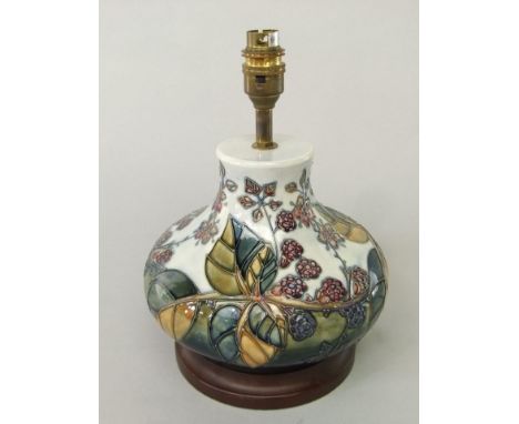 A Moorcroft table lamp base of onion shaped form, with painted blackberry and bramble detail, 18cm tall (minus fittings)